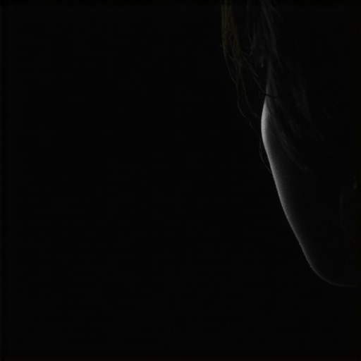 Person examining a monitor screen closely under bright light for defects