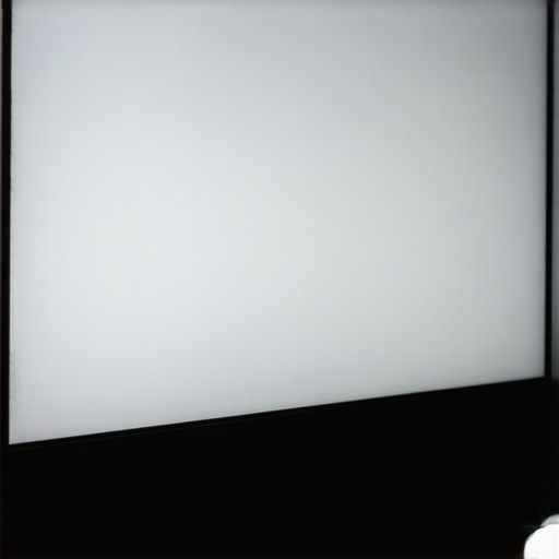 A monitor in a dark room showcasing smooth gray gradients and soft behind-screen ambient lighting